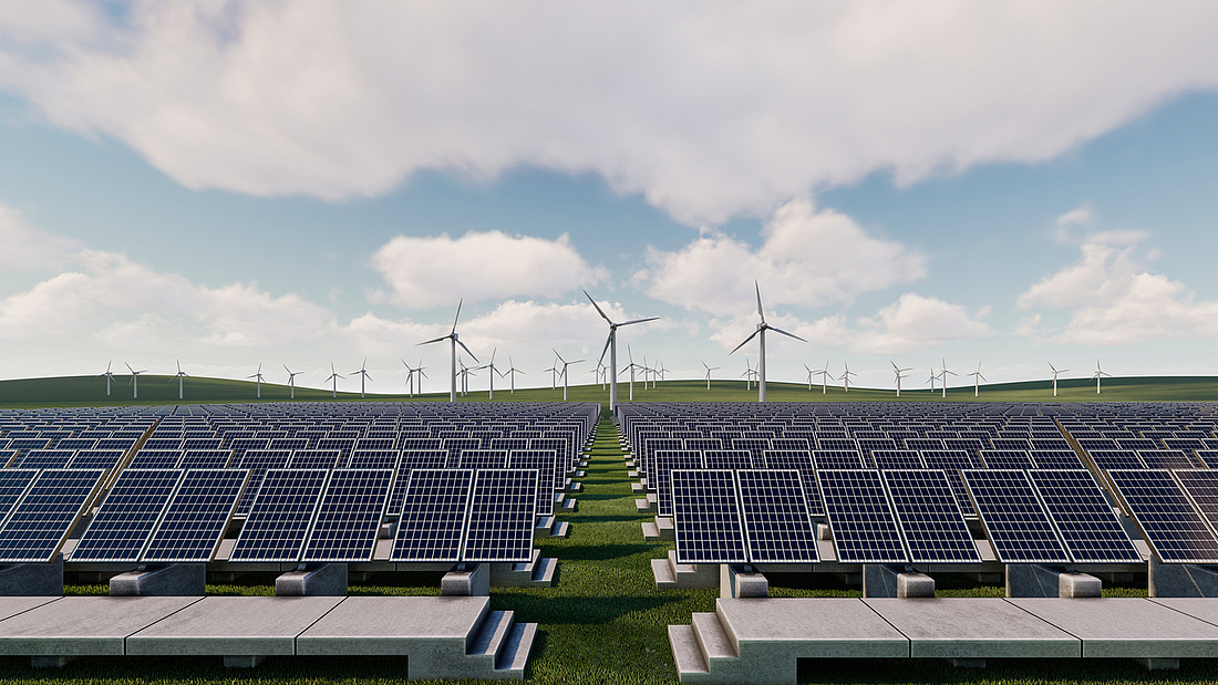 Durch mehrere Reihen von Sonnenkollektoren und Windkraftanlagen auf einem Feld entsteht grüne Energie.